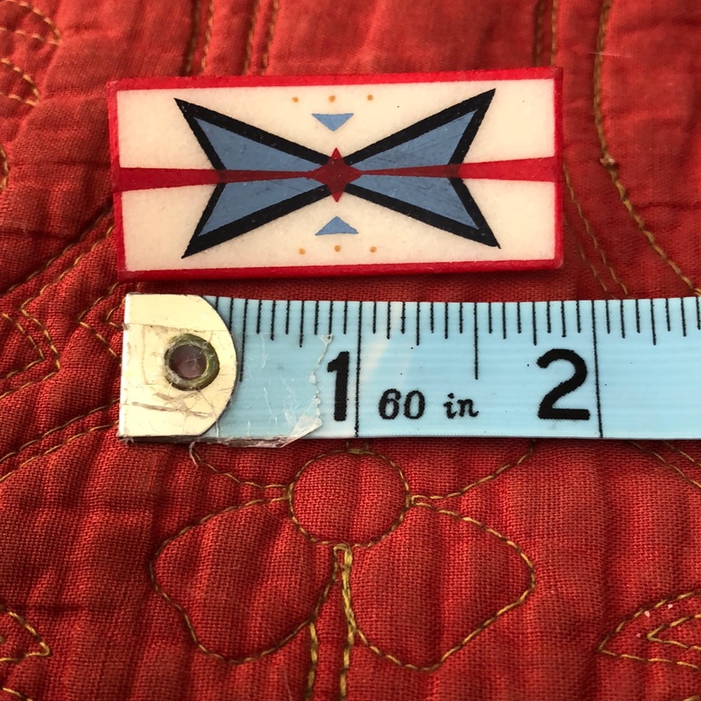 Unique handmade rawhide brooch pin .